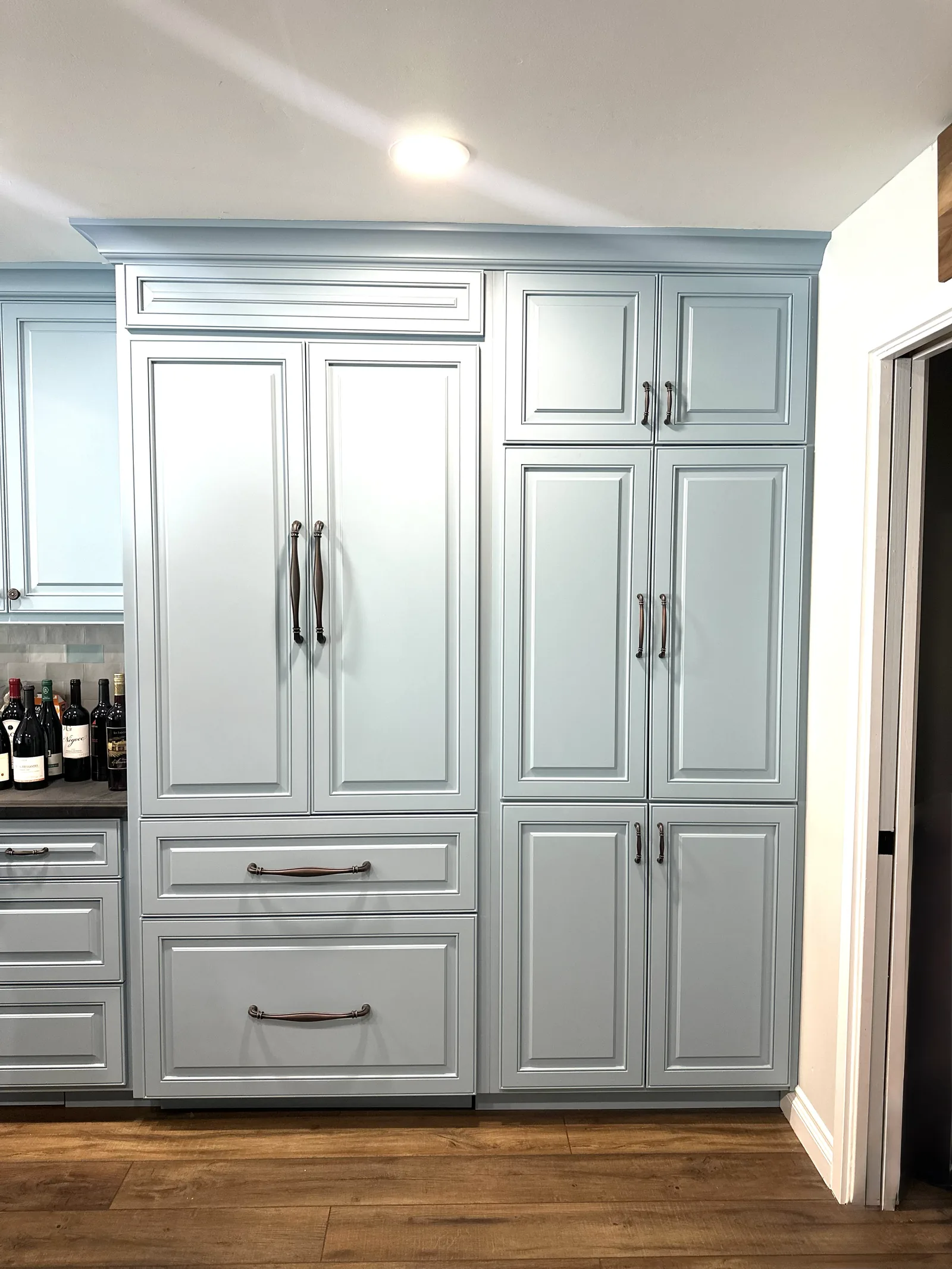 Light grey raised panel kitchen with a panel front refrigerator in Alameda