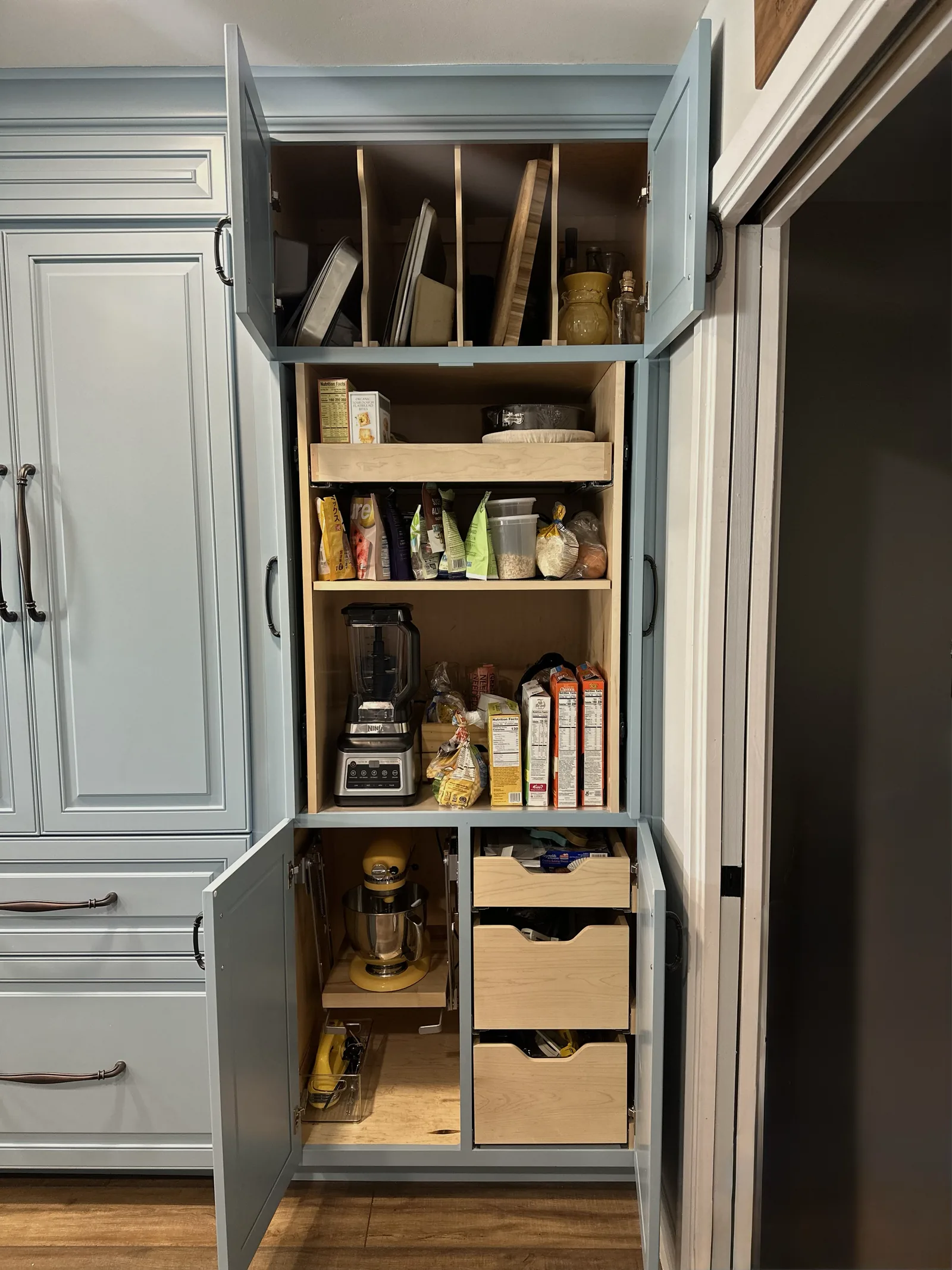 Painted pantry cabinet with full-extension pull-out shelves in Alameda