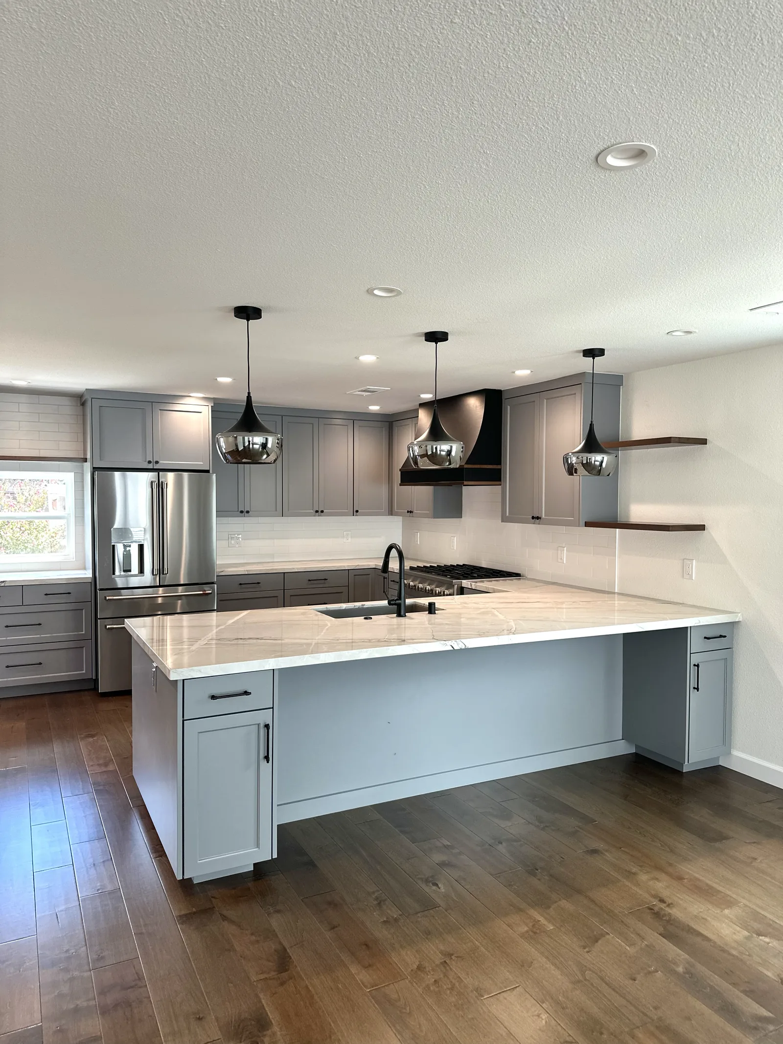 Grey shaker kitchen with a long island and pendant lighting in Fremont