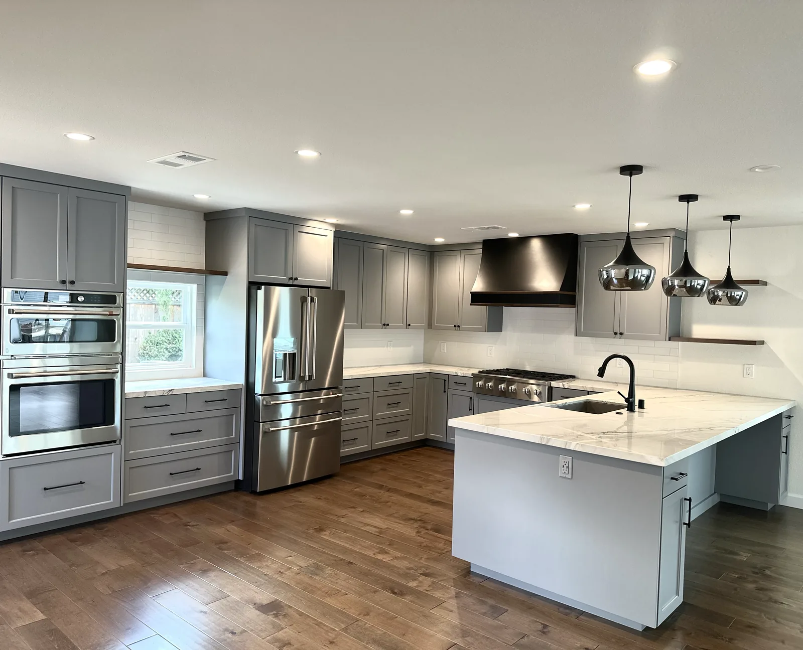 Grey shaker kitchen in an L-shaped layout with a central island in Fremont