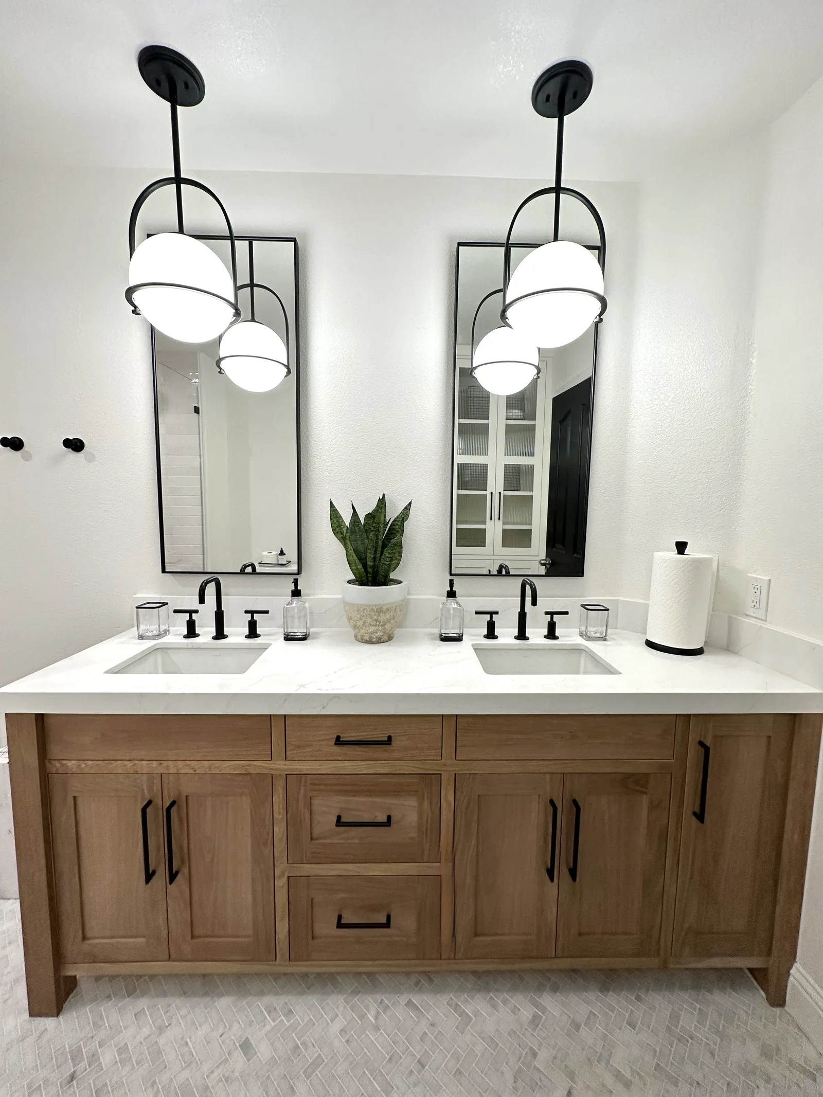 Oak double vanity with twin mirrors and matte black fixtures in Gilroy