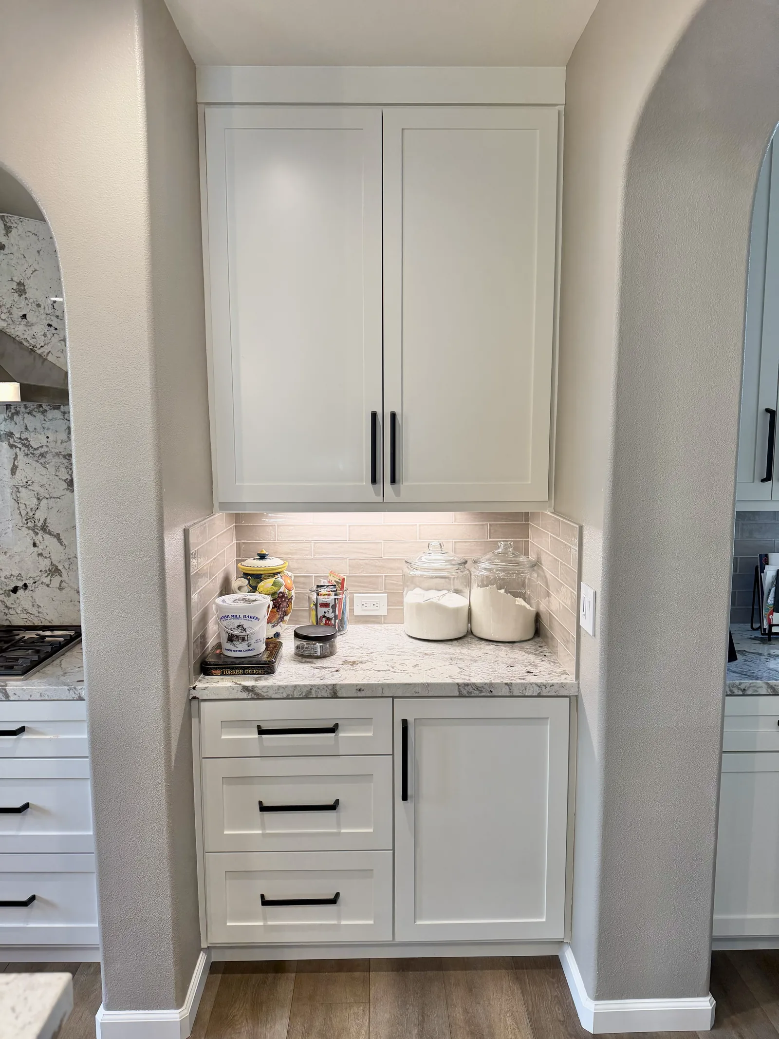 White shaker tall cabinet with a built-in coffee niche and granite top in Gilroy