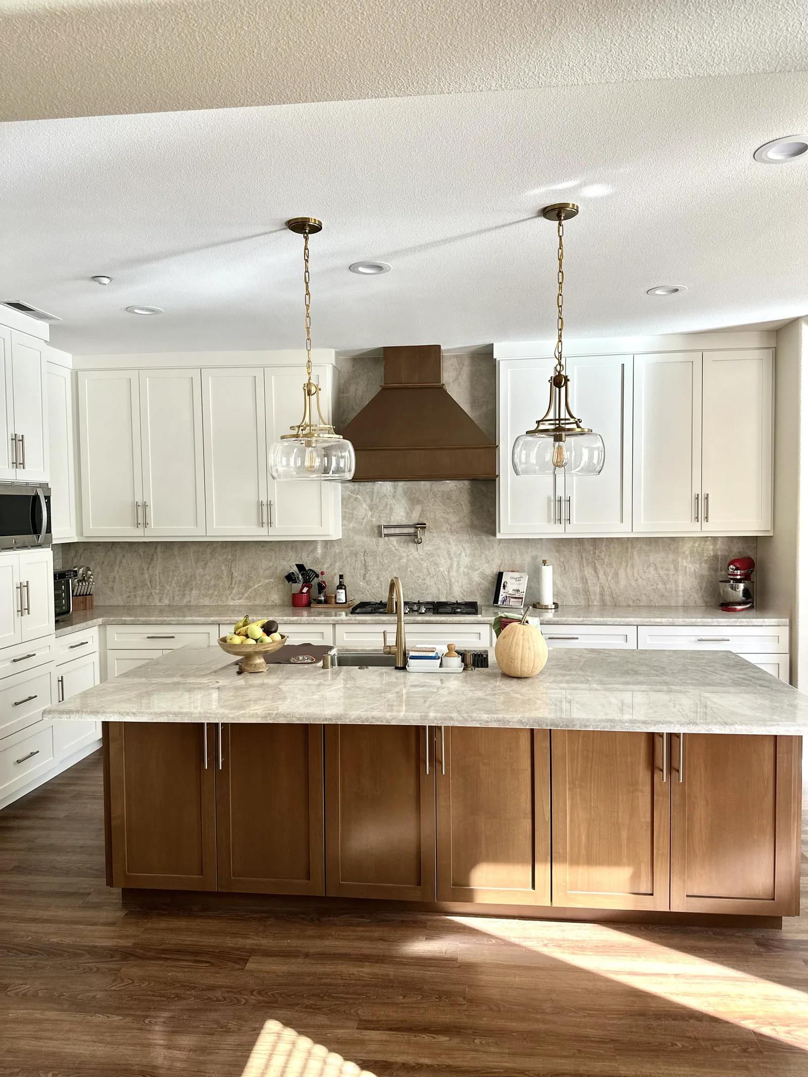 White shaker kitchen with a stained island and custom wood hood in Gilroy