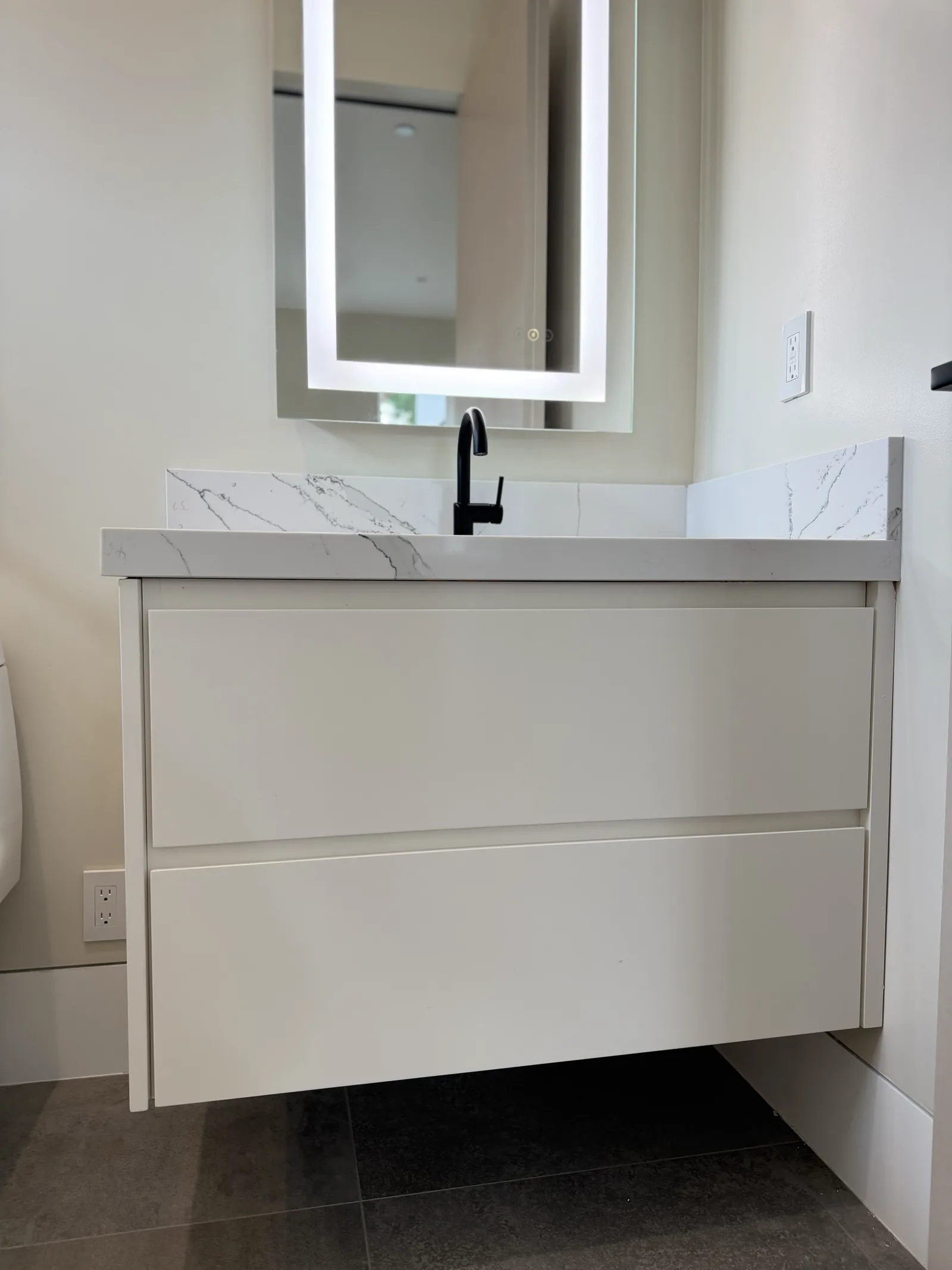 White floating vanity with a waterfall quartz top in a Los Altos bathroom