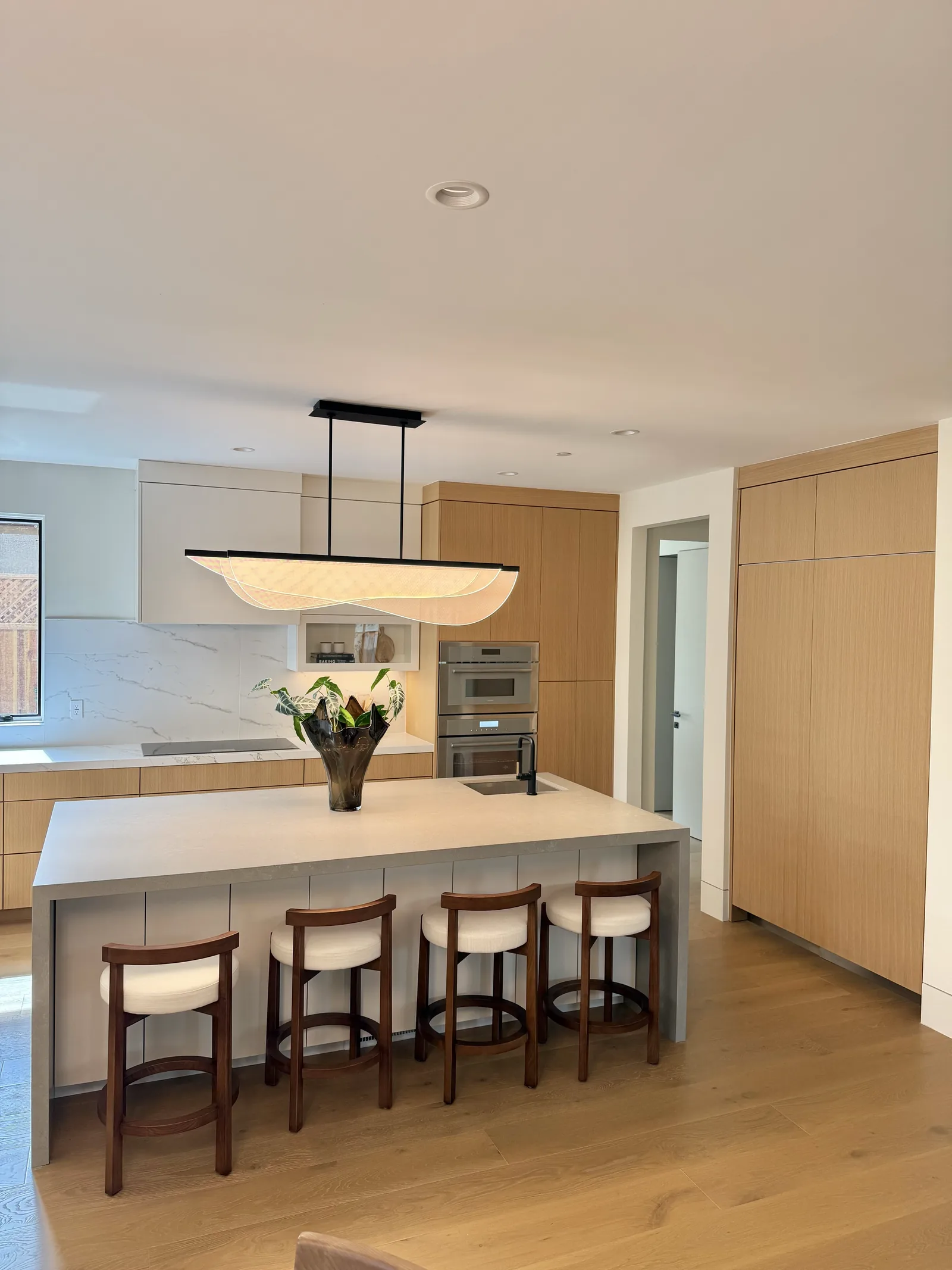 White oak kitchen island with seating for four in a Los Altos home