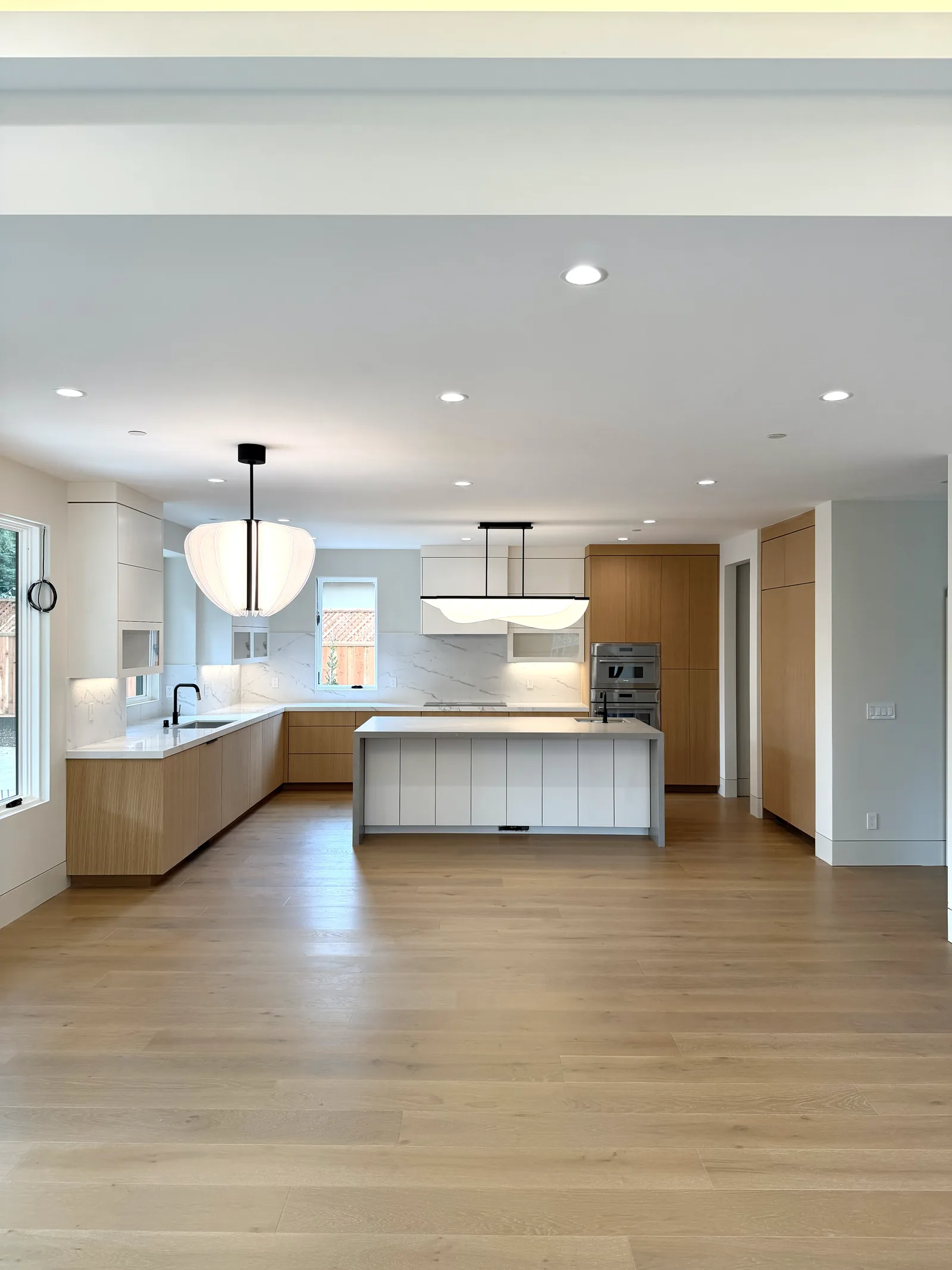 Modern white oak and white kitchen with a large island in a Los Altos home
