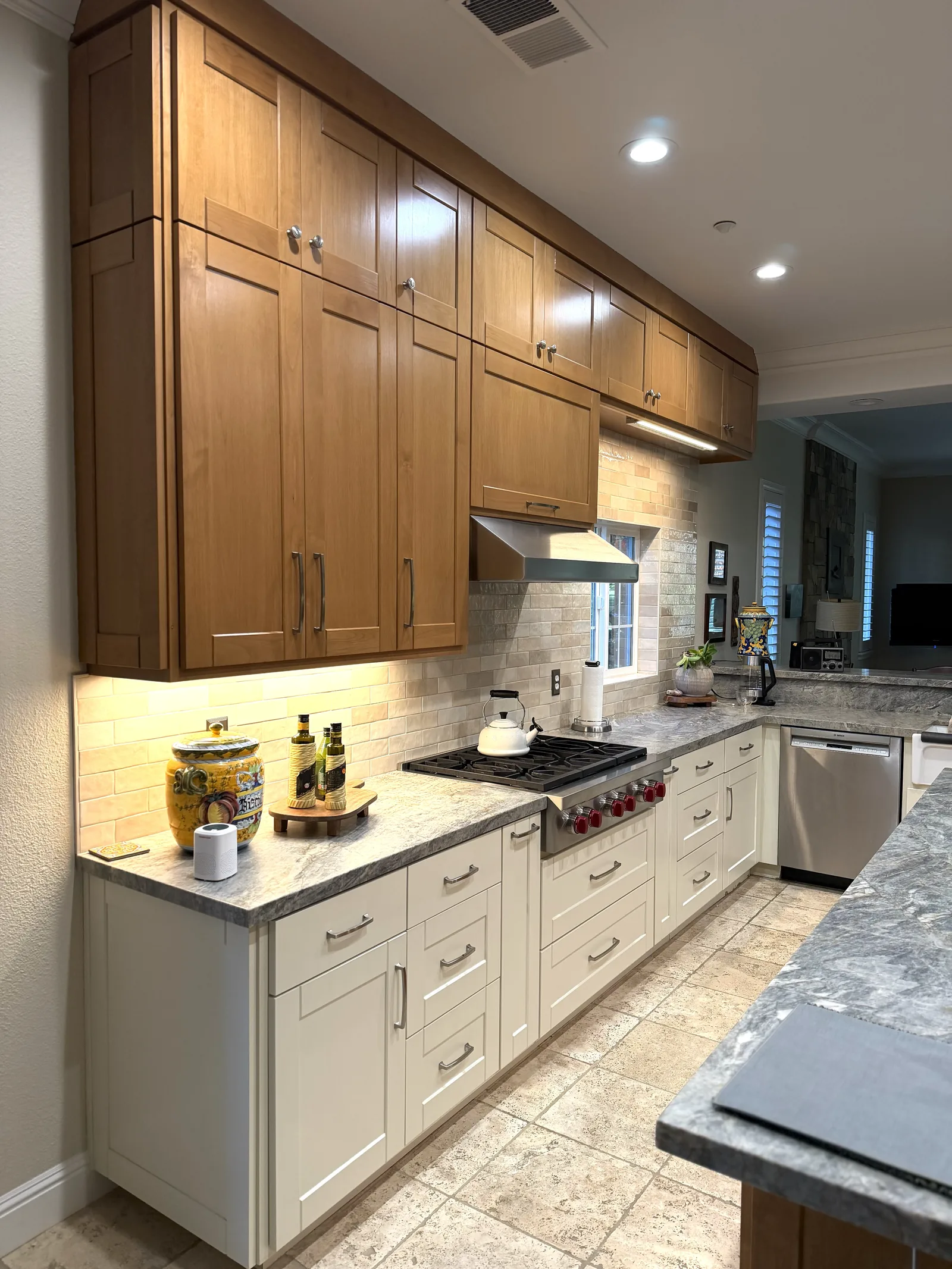Honey maple uppers over cream base cabinets with granite counters in Morgan Hill