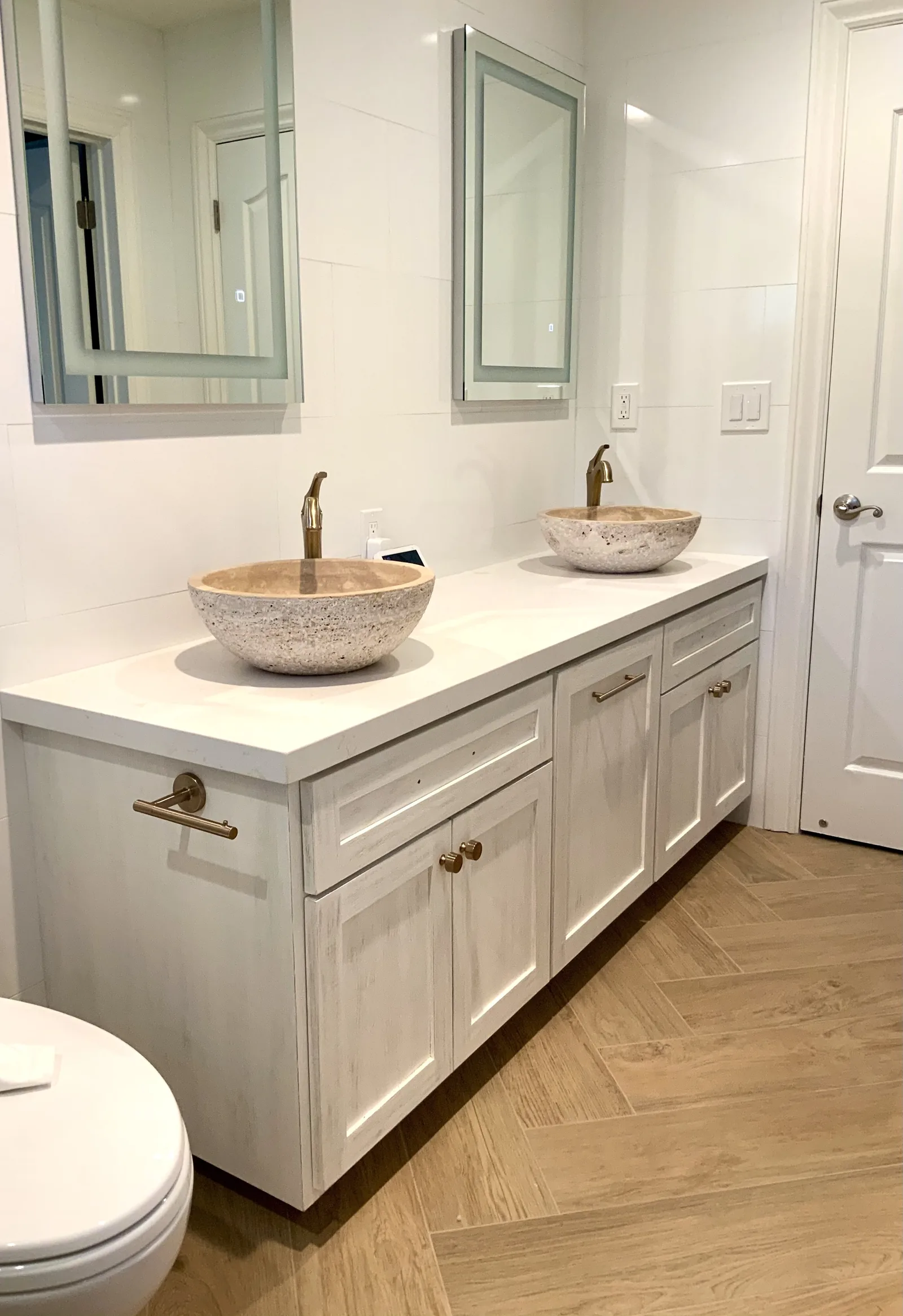 White shaker double vanity with vessel sinks and brass fixtures in Morgan Hill