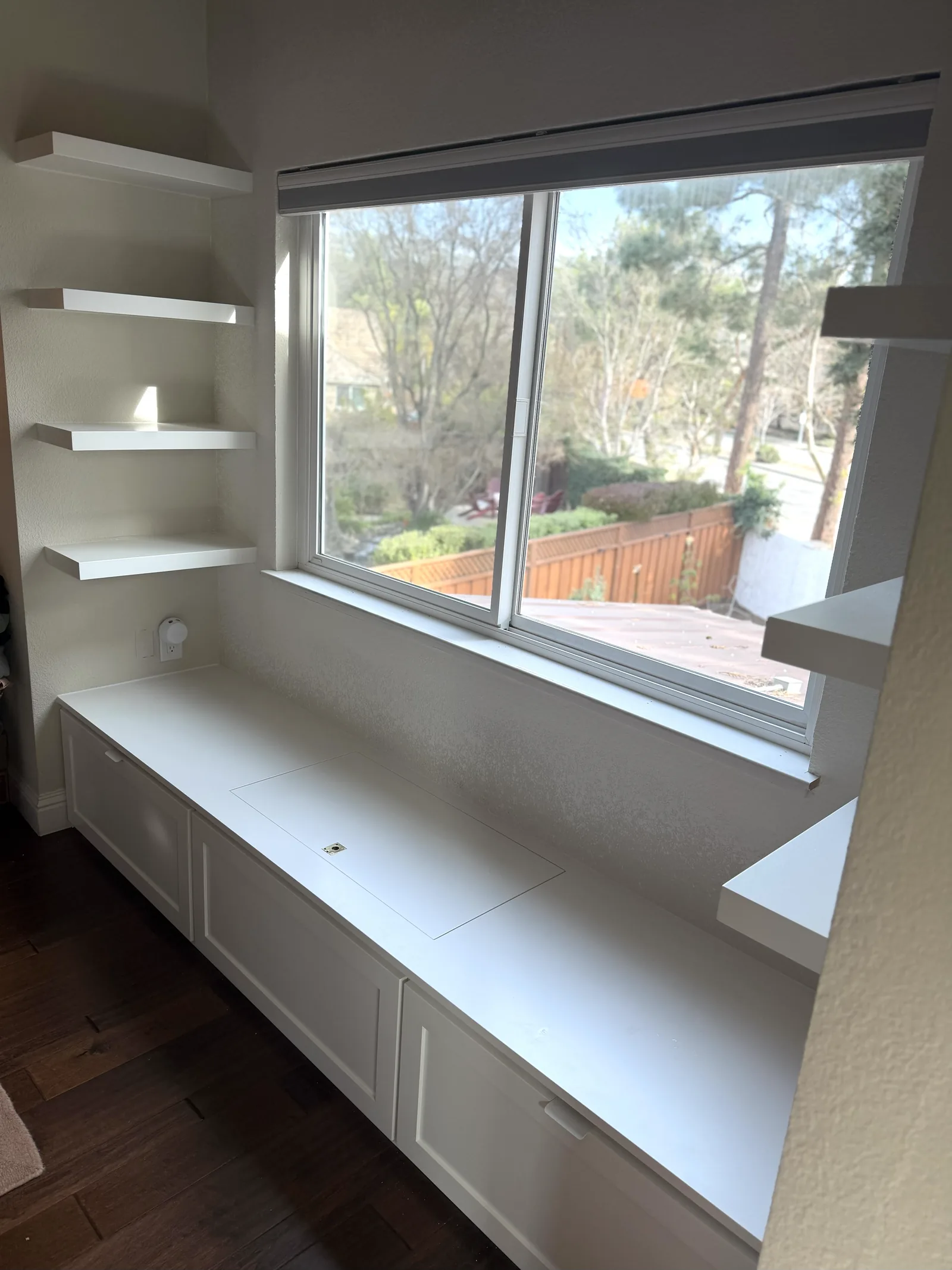 White window bench with drawer storage and floating shelves in Morgan Hill