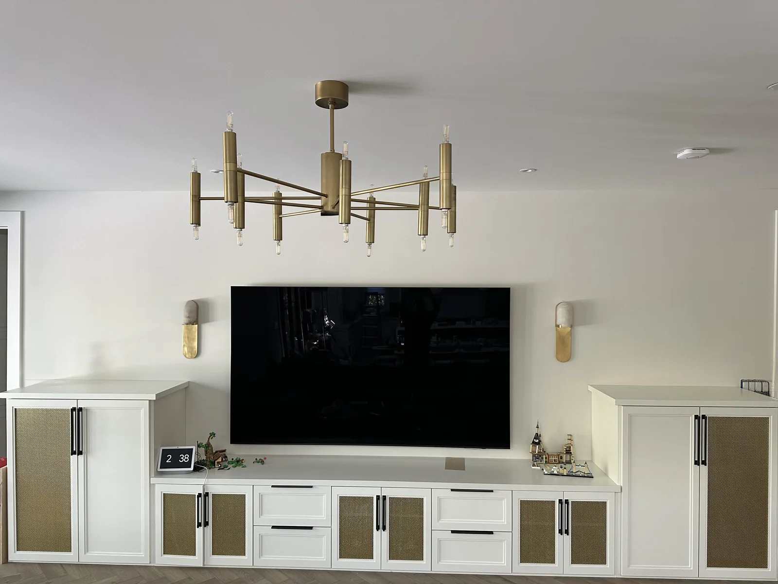 Media wall with white cabinetry and cane front doors in a Palo Alto home