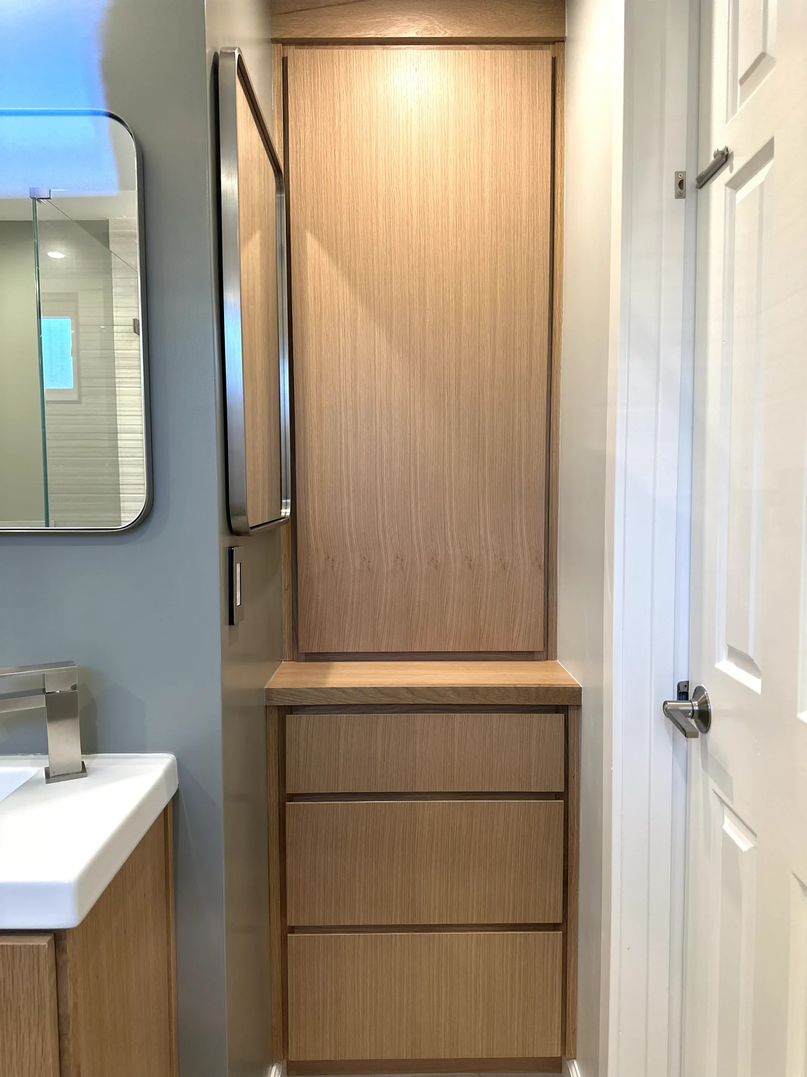 White oak vanity with a full height storage tower in a Palo Alto bathroom