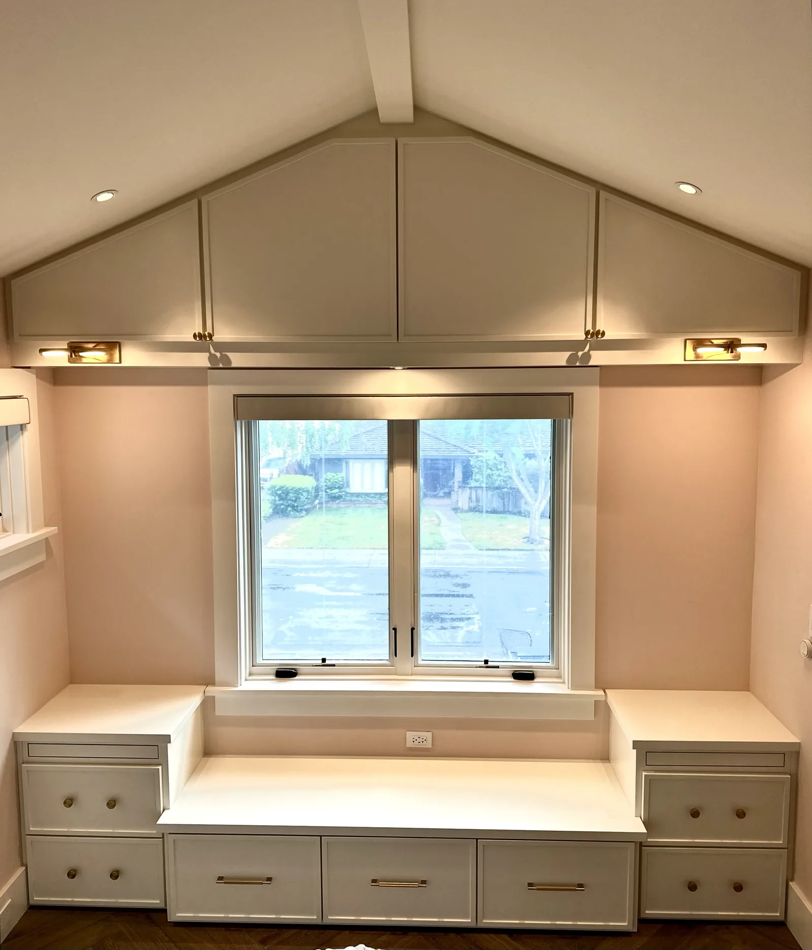 Greige window seat with a bank of drawers under a vaulted ceiling in Palo Alto