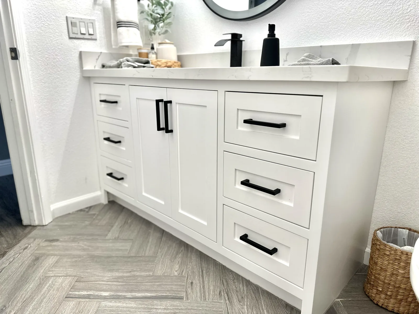 White shaker vanity with a corner drawer bank and quartz counter in Salinas