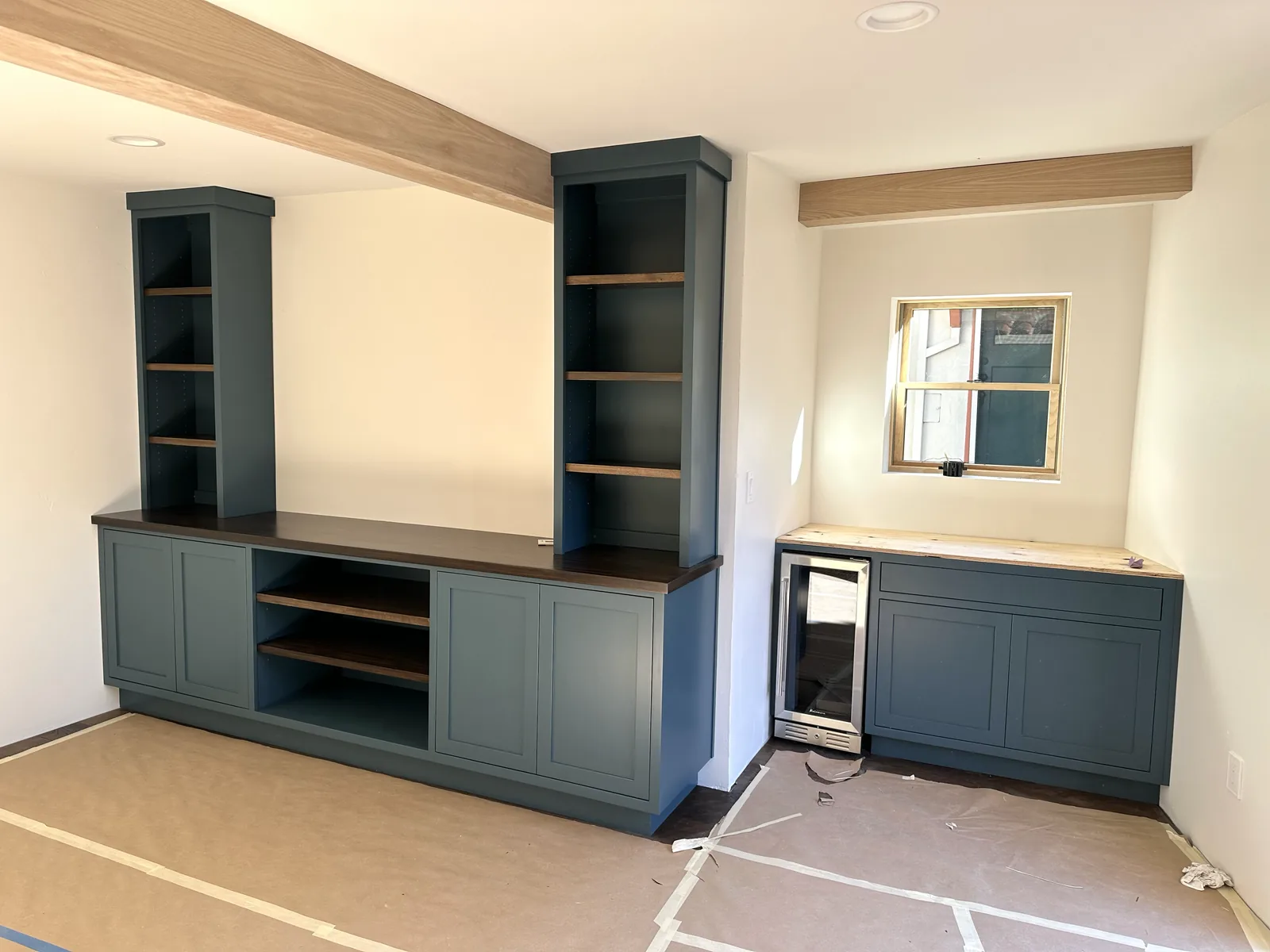 Navy built-in media and bar cabinet with a wine fridge in a San Jose home