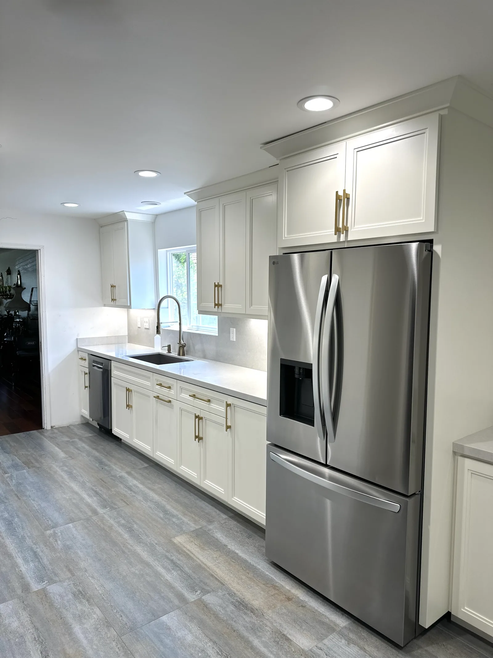 White kitchen with brass hardware and quartz counters in Santa Clara