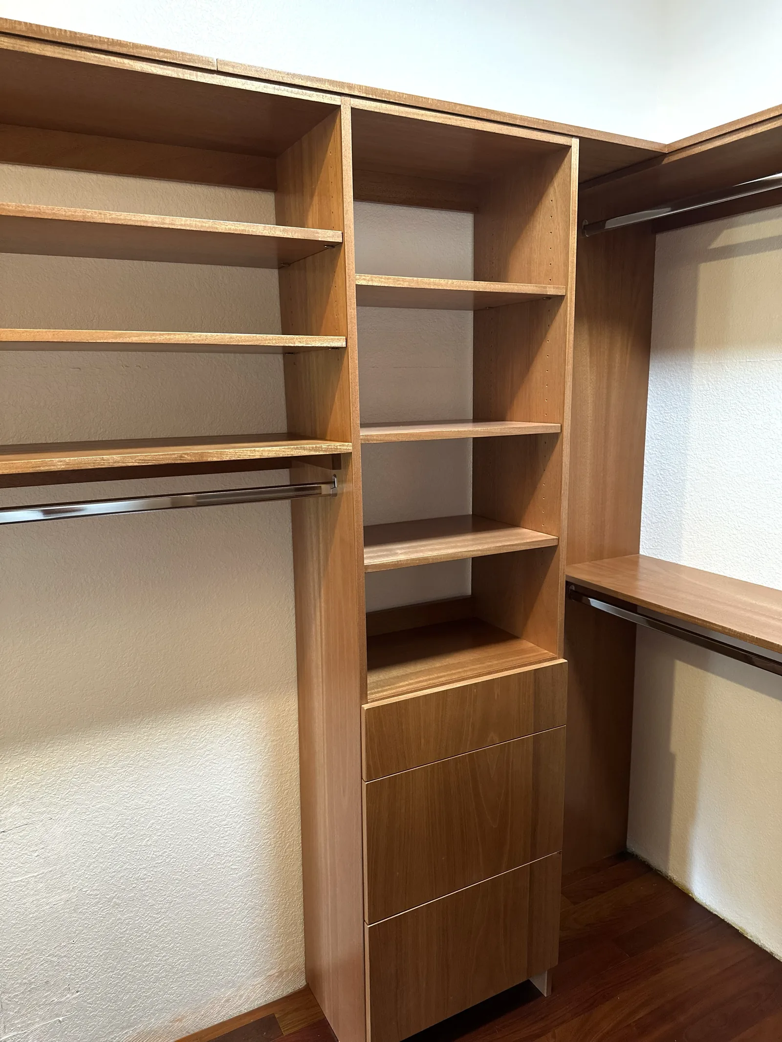 Custom closet with shelving towers and a built-in work surface in Scotts Valley