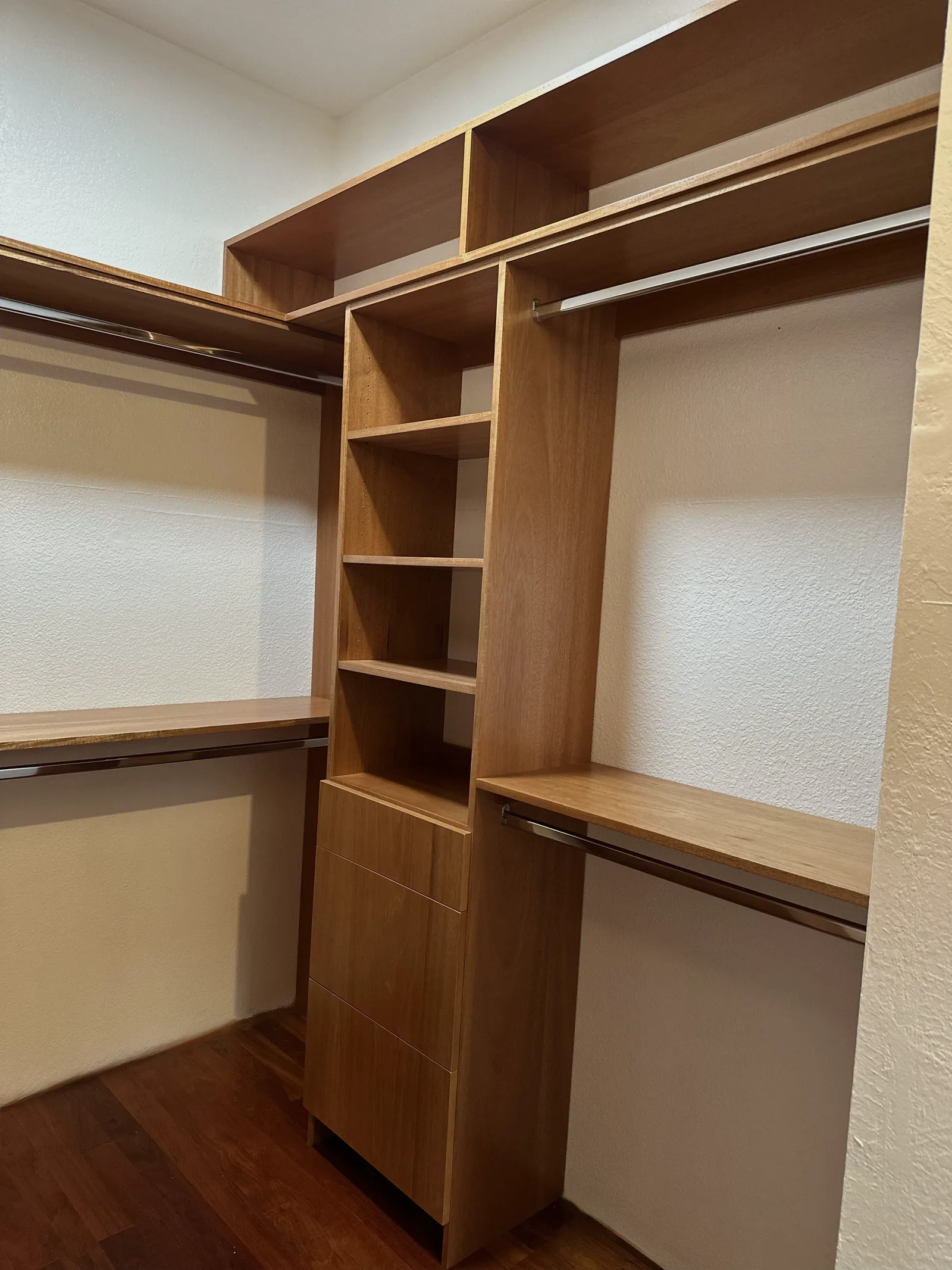 Walk-in closet with double hang rods and adjustable shelving in Scotts Valley